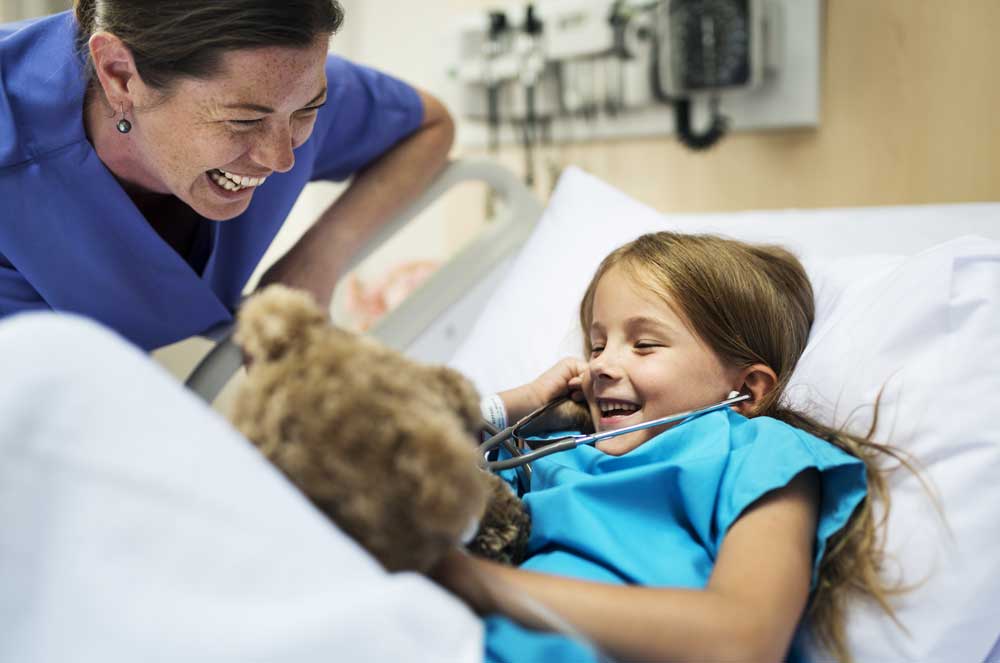 young girl smiling with nurse