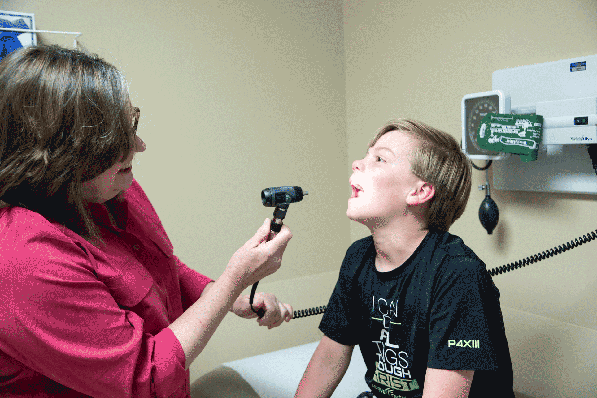 female doctor at St. Tammany Pediatrics Clinic examining boy