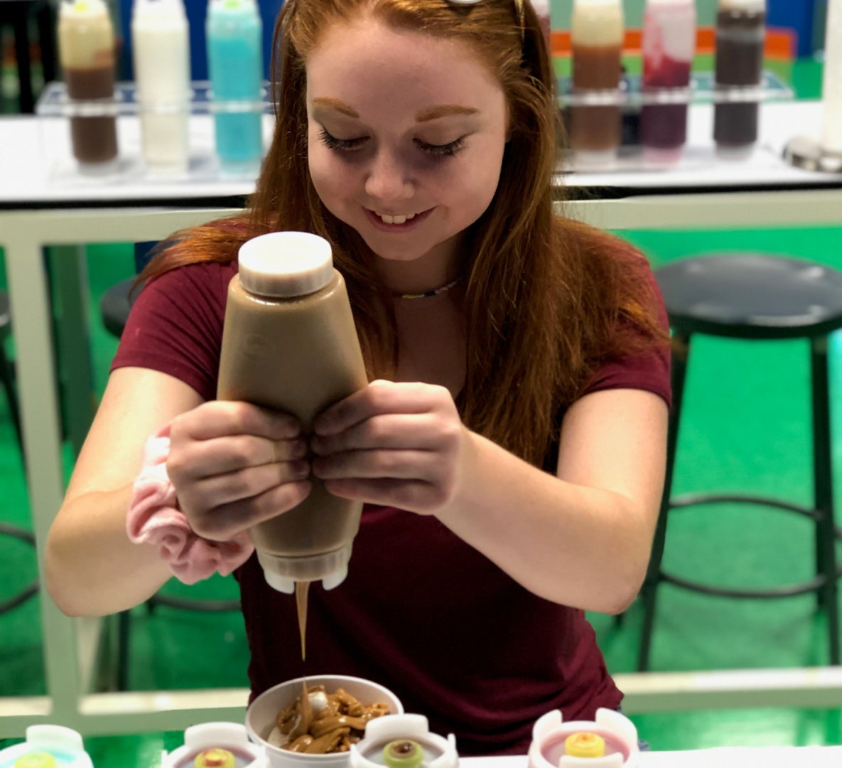 Girl putting topping on at test lab at Turkey Hill Experience