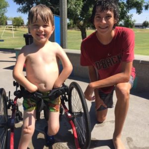 Two boys playing at Kiwanis Park Splash Pad - adaptive playground