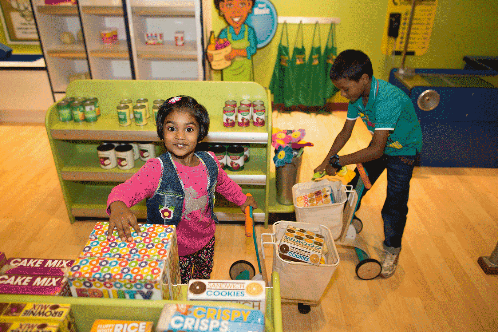 Young boy and girl playing market at Family Museum