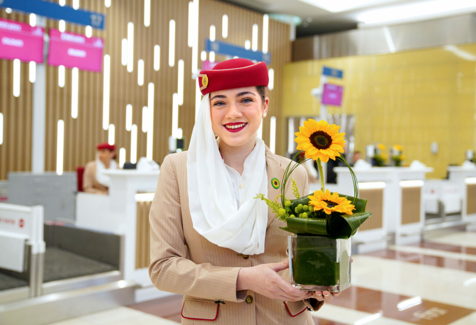 An Emirates flight crew holding a sunflower to symbolize hidden disabilities