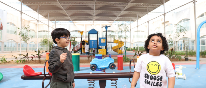 Two children at the playground area of Prince Faisal Bin Salman Autism Center