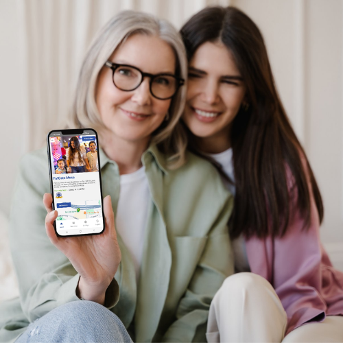 Mother and daughter displaying cellphone with a certified location shown