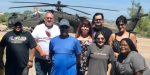 Boeing employees outside in front of a military helicopter