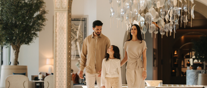 Family of 3 inside of the Palace Dubai Creek Harbour lobby