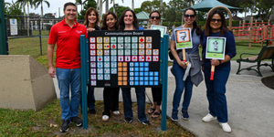 CCZ_scotts_place_wellington Village of Wellington employees standing in front of a communication board at Scott's Place accessible playground